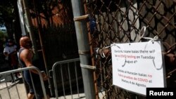 A sign informing that Tuesday testing will be canceled due to Hurricane Isaias is seen outside a community testing center for the coronavirus disease (COVID-19) in the Bronx borough of New York, Aug. 3, 2020. 