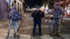 Members of the National Guard and police look on at a barricaded area a block from Bourbon Street, after at least 15 people were killed during an attack early in the morning on Jan. 1, 2025 in New Orleans, Louisiana.