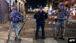 Members of the National Guard and police look on at a barricaded area a block from Bourbon Street, after at least 15 people were killed during an attack early in the morning on Jan. 1, 2025 in New Orleans, Louisiana.