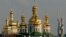 FILE - Golden cupolas of the 11th century Monastery of the Caves, holiest site of Orthodox Christians, beside the Soviet-era 62-meter tall Motherland statue, Kyiv.