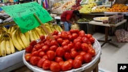 FILE - Mexican tomatoes are displayed for sale at a produce stand in Mercado Medellin, in Mexico City, Feb. 2, 2017. 