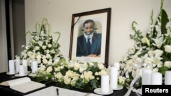 Candles, flowers, a condolences book and a portrait of deceased former Namibian President Sam Nujoma are placed at his residence, in Windhoek, Feb. 9, 2025.