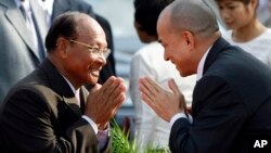 Cambodia's King Norodom Sihamoni, right, greets Heng Samrin, left, National Assembly President, before an annual royal plowing ceremony in Phnom Penh, Cambodia, file photo. 