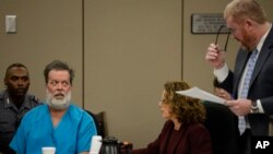 Robert Lewis Dear glares at his attorney Daniel King during an outburst in court appearance on Wednesday, Dec. 9, 2015, in Colorado Springs, Colo. Dear, accused of killing three people and wounding nine others at a Colorado Springs Planned Parenthood clinic on Nov. 27, was charged with first-degree murder. (Andy Cross/The Denver Post via AP, Pool)