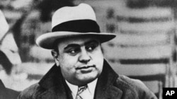 FILE - Chicago mobster Al Capone attends a football game, Jan. 19, 1931.