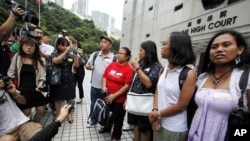 Eman Villanueva (L), vice chairperson of the Filipino Migrant Workers Union, and Dolores Balladares (2nd L), chairperson of United Filipinos in Hong Kong, along with other representatives, meet journalists outside the High Court in Hong Kong August 22, 20