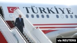 FILE - Turkish President Recep Tayyip Erdogan disembarks from his plane, Oct. 22, 2019. 