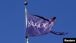A flag bearing the Yahoo company logo flies above a building in New York, Oct. 31, 2016. The European Commission has asked the U.S. about a secret court order Yahoo used to scan thousands of customer emails.
