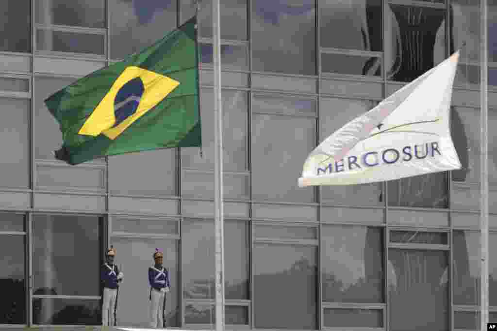 The Brazilian national flag along with a MERCOSUR banner fly at half-staff to honor plane crash victims, outside the Planalto Presidential Palace in Brasilia, Brazil. The Brazilian government declared three days of mourning.&nbsp;