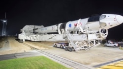 In this Monday, Nov. 9, 2020 photo provided by NASA, a SpaceX Falcon 9 rocket and Crew Dragon capsule is rolled out of the horizontal integration facility at Launch Complex 39A, as preparations continue for a crewed mission at NASA's Kennedy Space Center