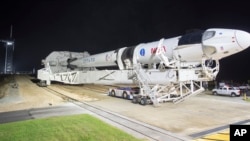 In this Monday, Nov. 9, 2020 photo provided by NASA, a SpaceX Falcon 9 rocket and Crew Dragon capsule is rolled out of the horizontal integration facility at Launch Complex 39A, as preparations continue for a crewed mission at NASA's Kennedy Space Center