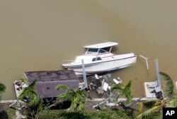 A boat is partially submerged in a canal in the wake of Hurricane Irma, Sept. 11, 2017, in Key Largo, Florida.