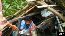 Villagers salvage items from their house damaged by cyclone Amphan in Midnapore, West Bengal, May 21, 2020. 