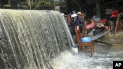 Massive water and flood debris caused by rains from passing Typhoon Megi flow through a residential district in Ilan county, north eastern Taiwan, 22 Oct 2010