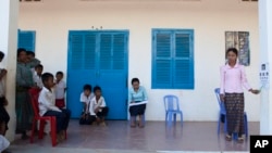 FILE - Teachers lead vision tests on students at a school in Siem Reap, Cambodia, Oct. 12, 2016, aided in part by Sightsavers International. In recognition of International Women’s Day 2025, the charity called to close the gender employment gap, particularly for the disabled.
