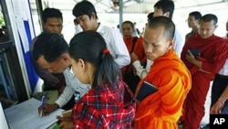 Cambodians and Buddhist monks register at the UN-backed war crimes tribunal for the three-day hearing of the former Khmer Rouge top leaders, Nuon Chea, who was Pol Pot's No. 2 and the group's chief ideologist, and Ieng Thirith, former minister of social a