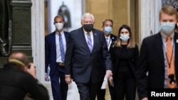 FILE - U.S. House Democratic Majority Leader Steny Hoyer, center, wears a face mask as he walks, accompanied by others, to the House Chamber ahead of a vote, on Capitol Hill in Washington, April 23, 2020.