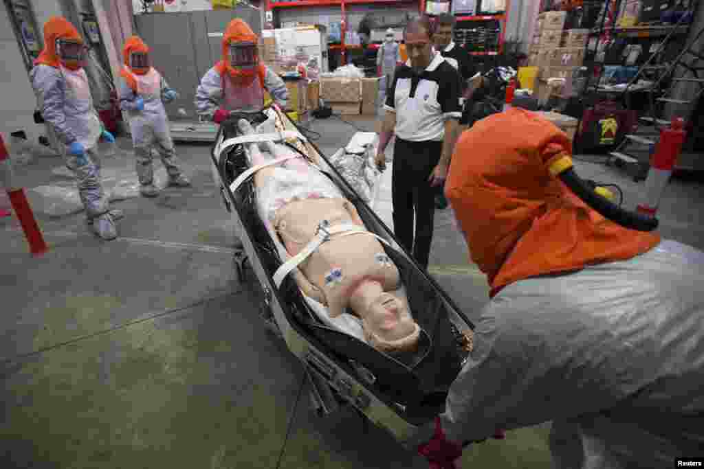 Volunteers who will be sent to Africa in the forthcoming days are taught how to work with patients infected with the Ebola virus during a training session at AP-HP Hospital Henri Mondor in Creteil, a suburb of Paris, Oct. 22, 2014. 