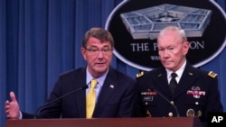 FILE - Defense Secretary Ash Carter is seen briefing reporters at the Pentagon. Behind him is Joint Chiefs Chairman General Martin Dempsey.