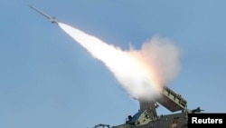 FILE - A rocket is fired during a drill of drone planes assaulting targets and a firing drill of self-propelled flak rocket destroying enemy cruise missiles coming in attack in low altitude, conducted by the air force, defense artillery units Korean People's Army in an undisclosed location in Pyongyang.