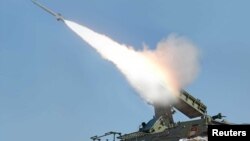 FILE - A rocket is fired during a drill of a self-propelled flak rocket destroying "enemy" cruise missiles conducted by the air defense artillery units of the Korean People's Army in an undisclosed location in North Korea.