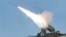 FILE - A rocket is fired during a drill of a self-propelled flak rocket destroying "enemy" cruise missiles conducted by the air defense artillery units of the Korean People's Army in an undisclosed location in North Korea.