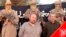 French nationals Philippe Verdon and Serge Lazarevic are seen surrounded by masked men holding guns in an undisclosed location in Mali, in this undated handout picture. 