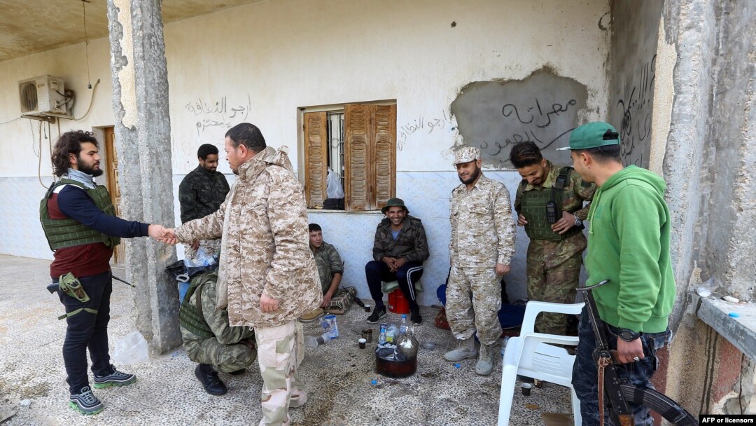 Para kombatan yang setia kepada pemerintah Libya yang diakui oleh internasional, GNA, beristirahat di sebuah tempat di selatan Ibu Kota Libya, Tripoli, 12 Januari 2020. Pihak-pihak yang bertikai di Libya setuju untuk gencatan senjata.