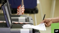 FILE - A voter casts his primary ballot in Hialeah, Fla. Paper ballots protect against electronic hackers, a Johns Hopkins University cryptography expert says.