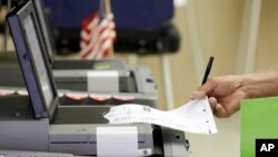 FILE - A voter casts his primary ballot in Hialeah, Fla. Paper ballots protect against electronic hackers, a Johns Hopkins University cryptography expert says.