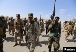 FILE - Iran-backed forces allied with Iraqi forces in Ouja, on the southern outskirts of Tikrit, March 26, 2015. The U.S. conditioned its entry into Iraq's battle to retake Tikrit from IS on the withdrawal of Shiite militias from the clearing operation.