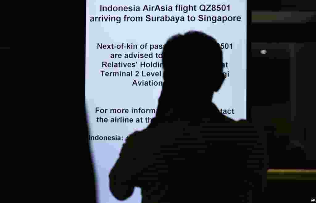 Nhân viên phi trường hướng dẫn thân nhân của các hành khách tập trung tại một khu vực ở sân bay quốc tế Changi, Singapore, nơi chuyến bay được dự kiến hạ cánh, ngày 28/12/2014.
