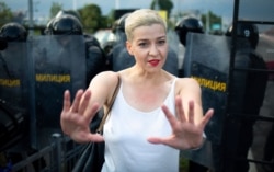 FILE - Maria Kolesnikova, one of Belarus' opposition leaders, gestures during a rally in Minsk, Belarus, Aug. 30, 2020.