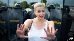 FILE - Maria Kolesnikova, one of Belarus' opposition leaders, gestures during a rally in Minsk, Belarus, Aug. 30, 2020.
