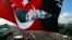 An anti-government protester waves a Turkish flag depicting the founder of modern Turkey Mustafa Kemal Ataturk as thousands of protesters gather in Istanbul's Taksim square, June 9, 2013.