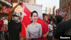 FILE - Demonstrators protest against the military coup and demand the release of elected leader Aung San Suu Kyi, in Yangon, Myanmar, Feb. 6, 2021. 
