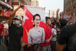FILE - Demonstrators protest against the military coup and demand the release of elected leader Aung San Suu Kyi, in Yangon, Myanmar, Feb. 6, 2021.