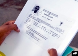 Hiwet Tesfamariam Berhe holds photocopies of documents she told the Associated Press belong to her brother Medhane Tesfamariam Berhe, in Oslo, June 9, 2016.