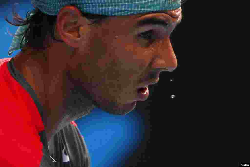 Sweat drips from Rafael Nadal of Spain&#39;s nose during a men&#39;s singles match against Kei Nishikori of Japan at the Australian Open 2014 tennis tournament in Melbourne.