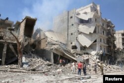 Men inspect a damaged building after airstrikes on a rebel-held neighborhood of Aleppo, Syria, Aug. 27, 2016.