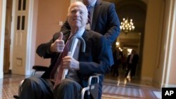 FILE - Sen. John McCain, R-Ariz., leaves a closed-door session where Republican senators met on the GOP effort to overhaul the tax code, on Capitol Hill in Washington, Dec. 1, 2017.