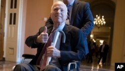 FILE - Sen. John McCain, R-Ariz., leaves a closed-door session where Republican senators met on the GOP effort to overhaul the tax code, in Washington, Dec. 1, 2017.