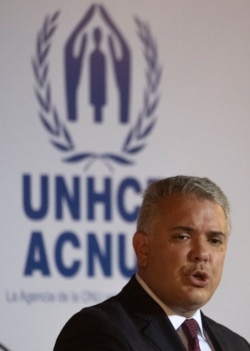 Colombian President Ivan Duque holds a press conference with UN High Commissioner for Refugees Italian Filippo Grandi in Bogota on Feb. 8, 2021.