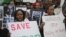 FILE - Burundi nationals from the U.S. and Canada and their supporters demonstrate outside U.N. headquarters in New York, calling for an end to political atrocities and human rights violations under the government of President Pierre Nkurunziza, April 26, 2016. 