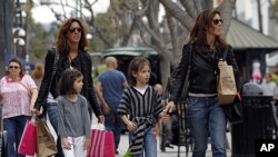 Women and girls carry purchases on the Third Street Promenade in Santa Monica, Calif., April 24, 2012.