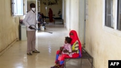 A man disinfects a rural isolation center where patients are being treated for cholera in Wad Al-Hilu in Kassala state in eastern Sudan, on Aug. 17, 2024.