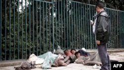 An Ethiopian man uses his mobile phone to take a picture of street children sleeping on a street of Addis Ababa in Ethiopia, (File photo).