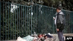 An Ethiopian man uses his mobile phone to take a picture of street children sleeping on a street of Addis Ababa in Ethiopia, (File photo).