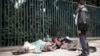 An Ethiopian man uses his mobile phone to take a picture of street children sleeping on a street of Addis Ababa in Ethiopia, (File photo).