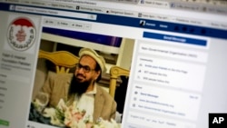 FILE - A photo shows a Facebook site that features one of India’s most wanted, Hafiz Saeed, the founder of Lashkar-e-Taiba, a banned organization and a U.S. declared terrorist group, in Islamabad, Pakistan, July 7, 2017. 